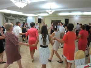 Dancing the Hora is a Moldovan custom where people interlock hands and move in circles together to the music.
